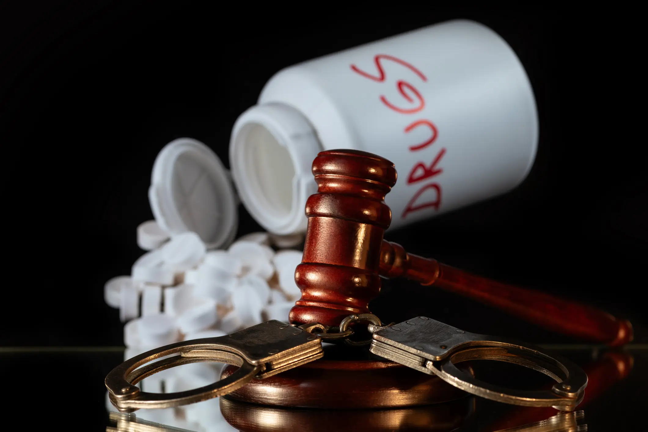 Handcuffs, Judge's Gavel and Pills