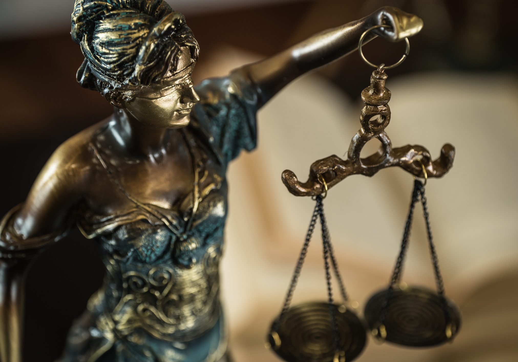Law and Justice concept. Mallet of the judge, books, scales of justice. Gray stone background, reflections on the floor, place for typography. Courtroom theme.